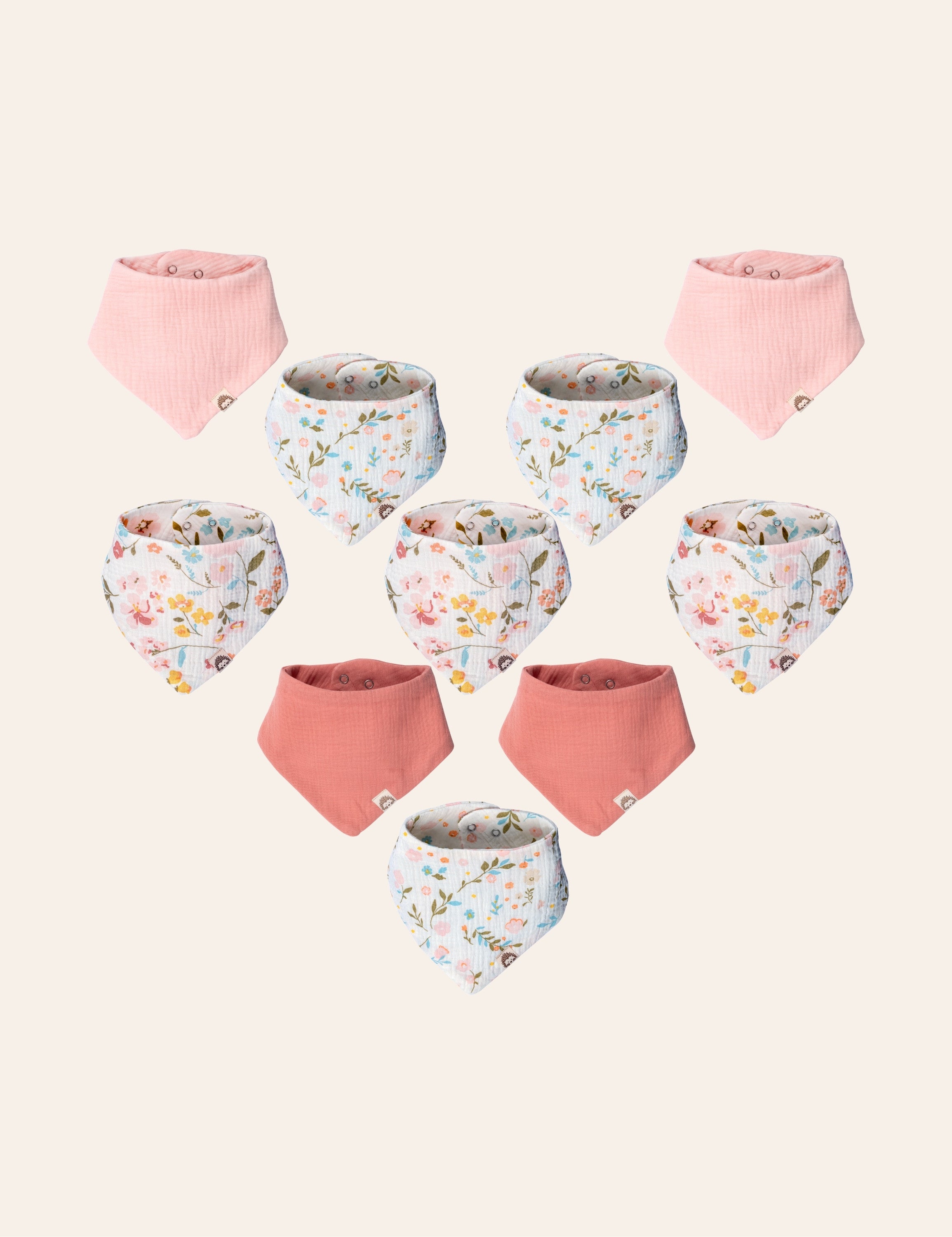 10 set of floral patterned muslin baby bandana bibs with floral and solid pink designs on a light beige background