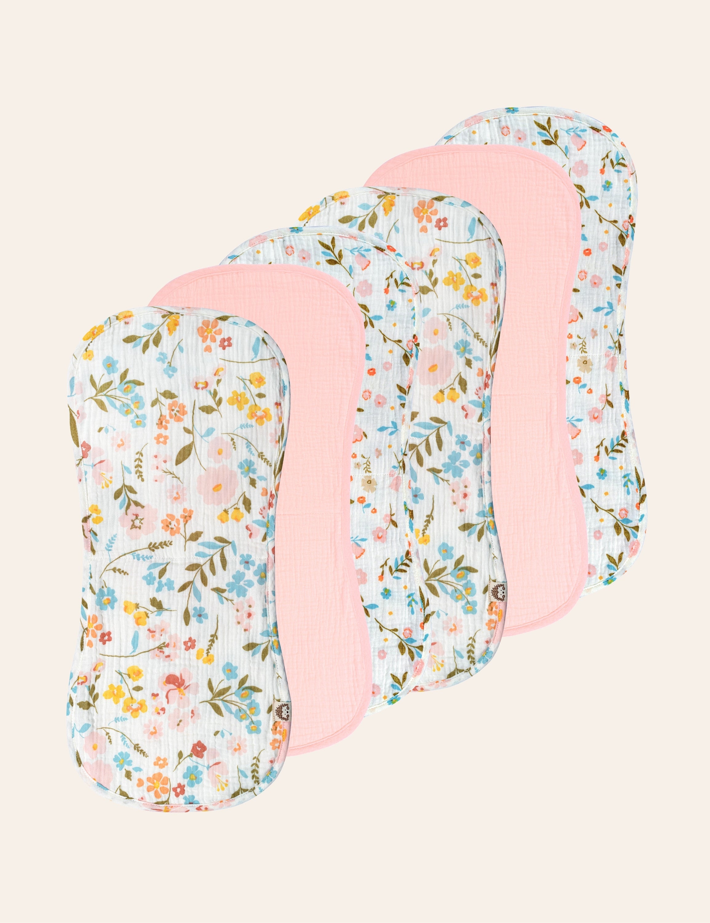 Six floral-patterned and solid pink colored muslin burp cloths