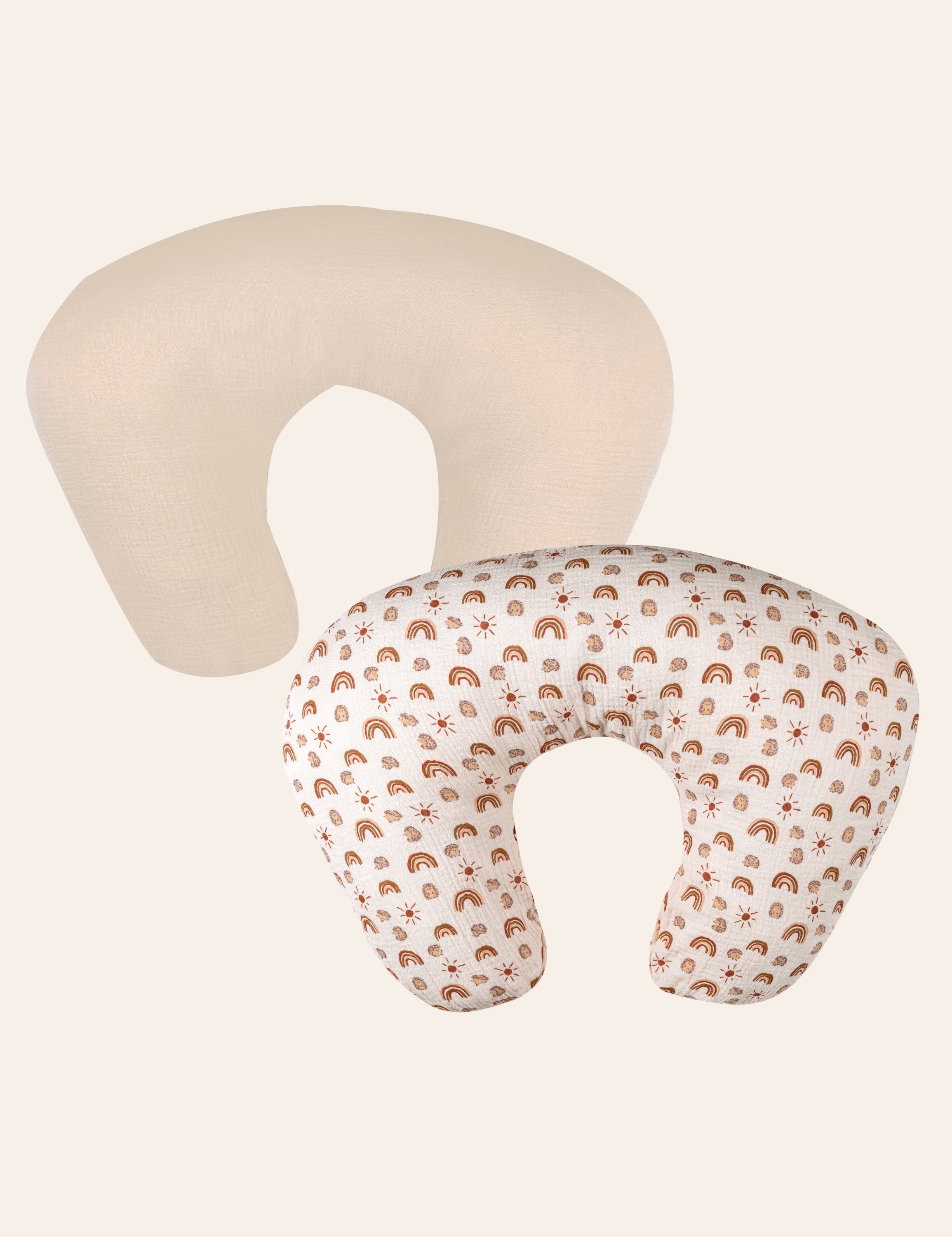Two U-shaped muslin nursing pillows, one plain beige and one patterned with brown dots on a white background.