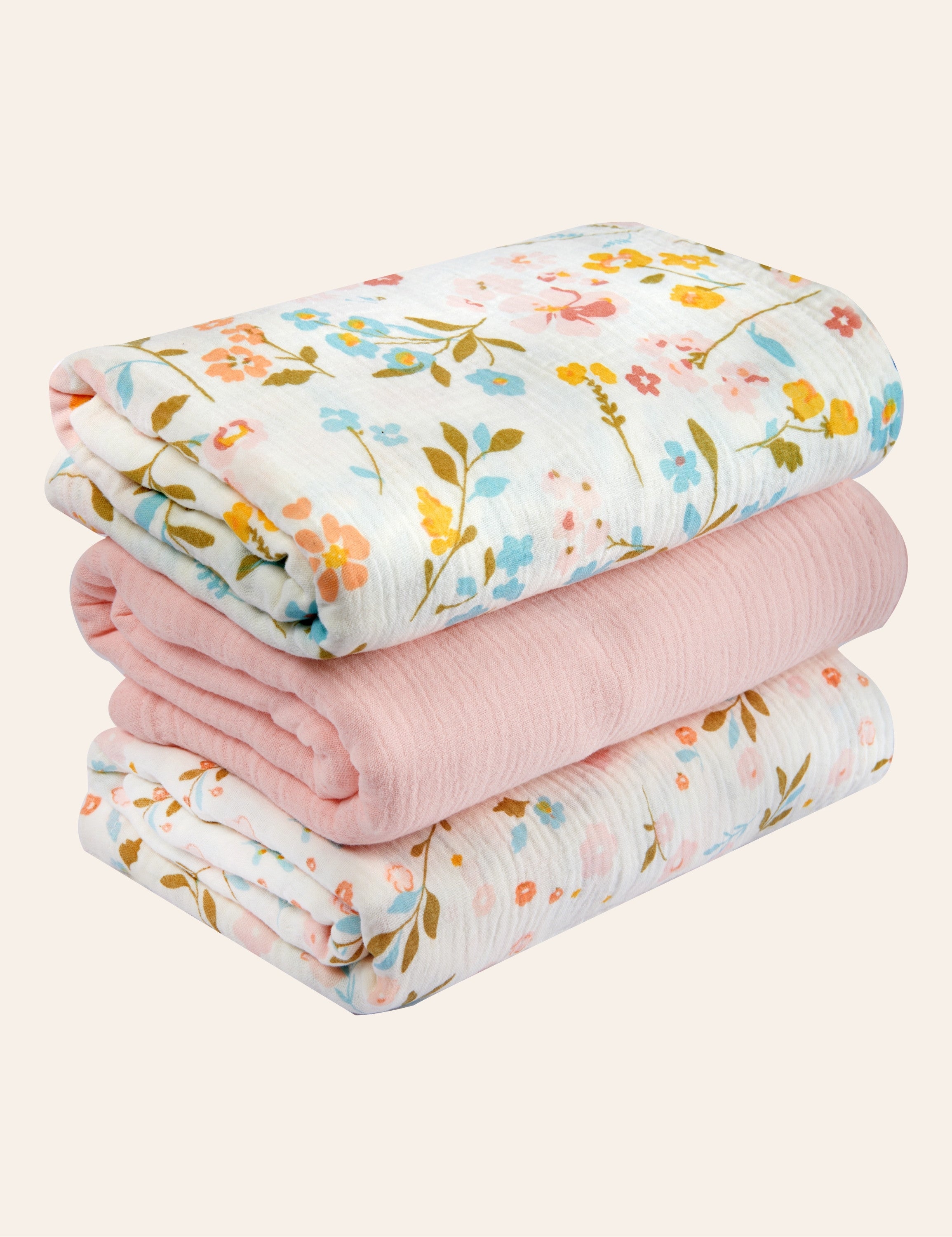 Stack of folded muslin baby swaddle blankets with floral patterns on a white background