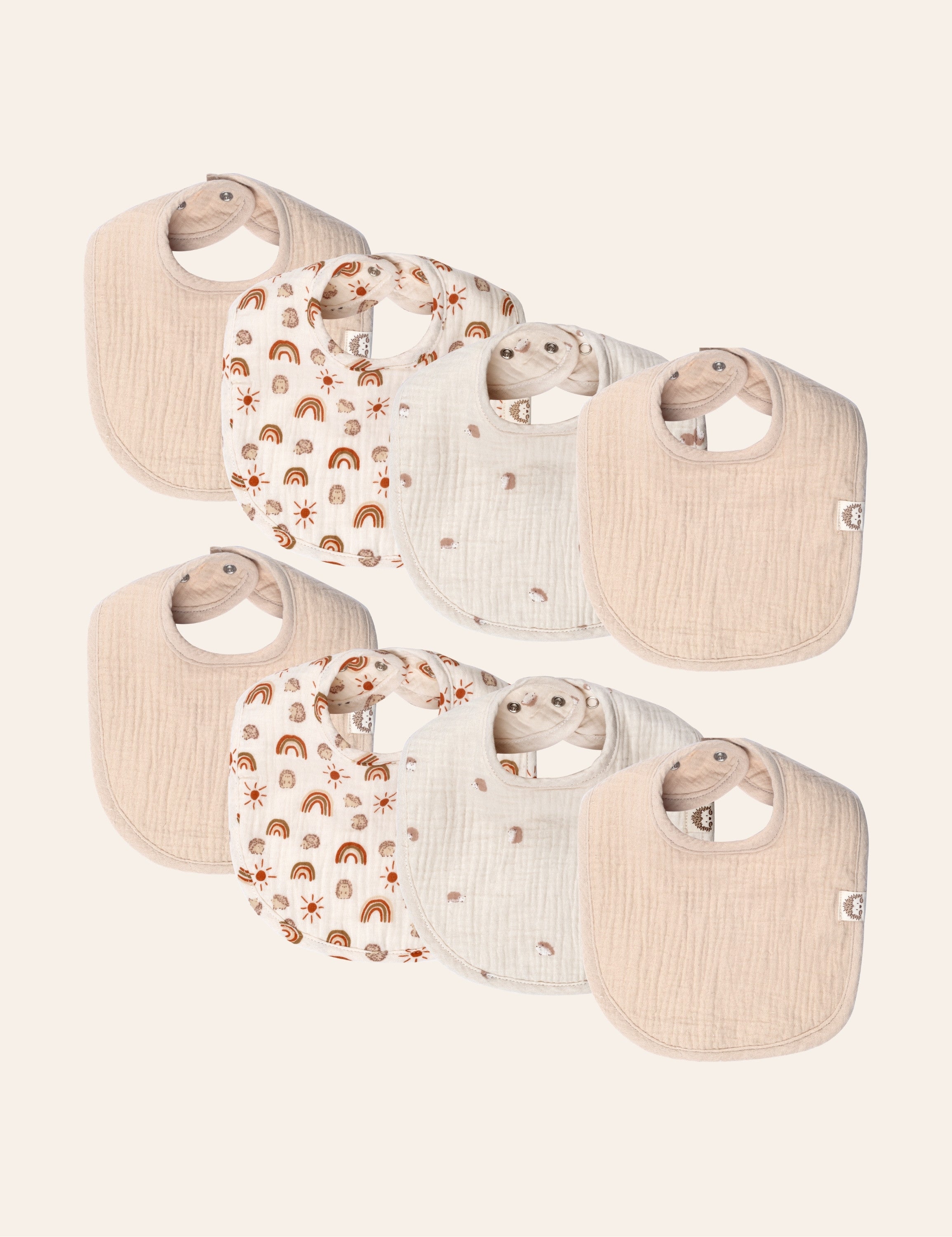 8 piece of muslin baby bibs with different patterns on a white background