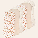 Six muslin baby bibs with different patterns on a white background