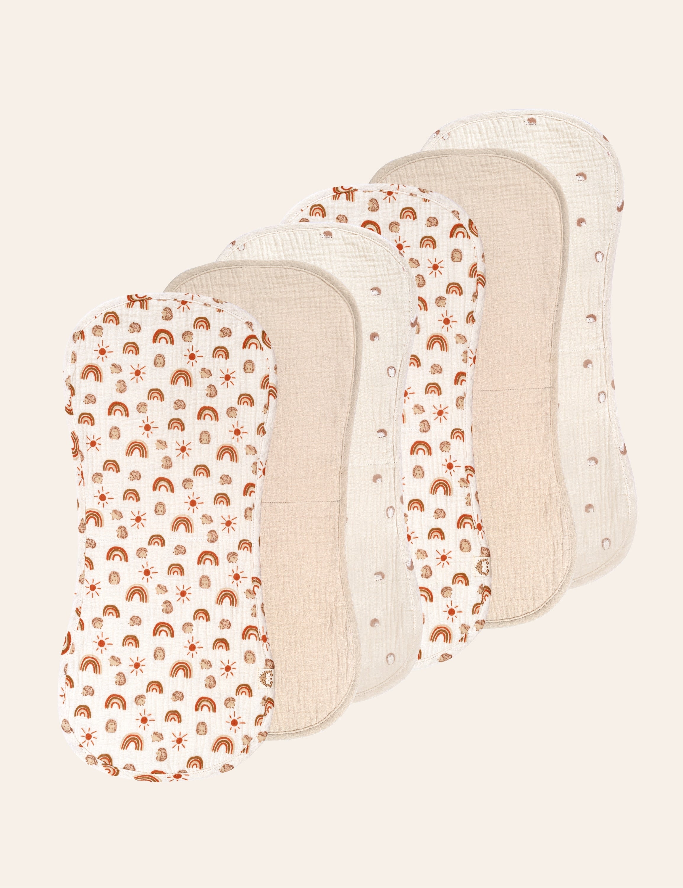 Six muslin baby bibs with different patterns on a white background