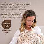 Mother holding her baby wrapped in a rainbow patterned muslin nursing cover with text about product features and OEKO-TEX certification.