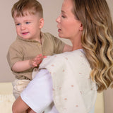 Mother holding her baby with hedgehog printed muslin burp clothes on her shoulder
