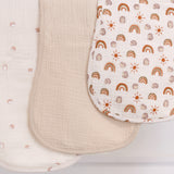 Three burp cloths, one solid beige, one with rainbow pattern and one with hedgehog illustrations.