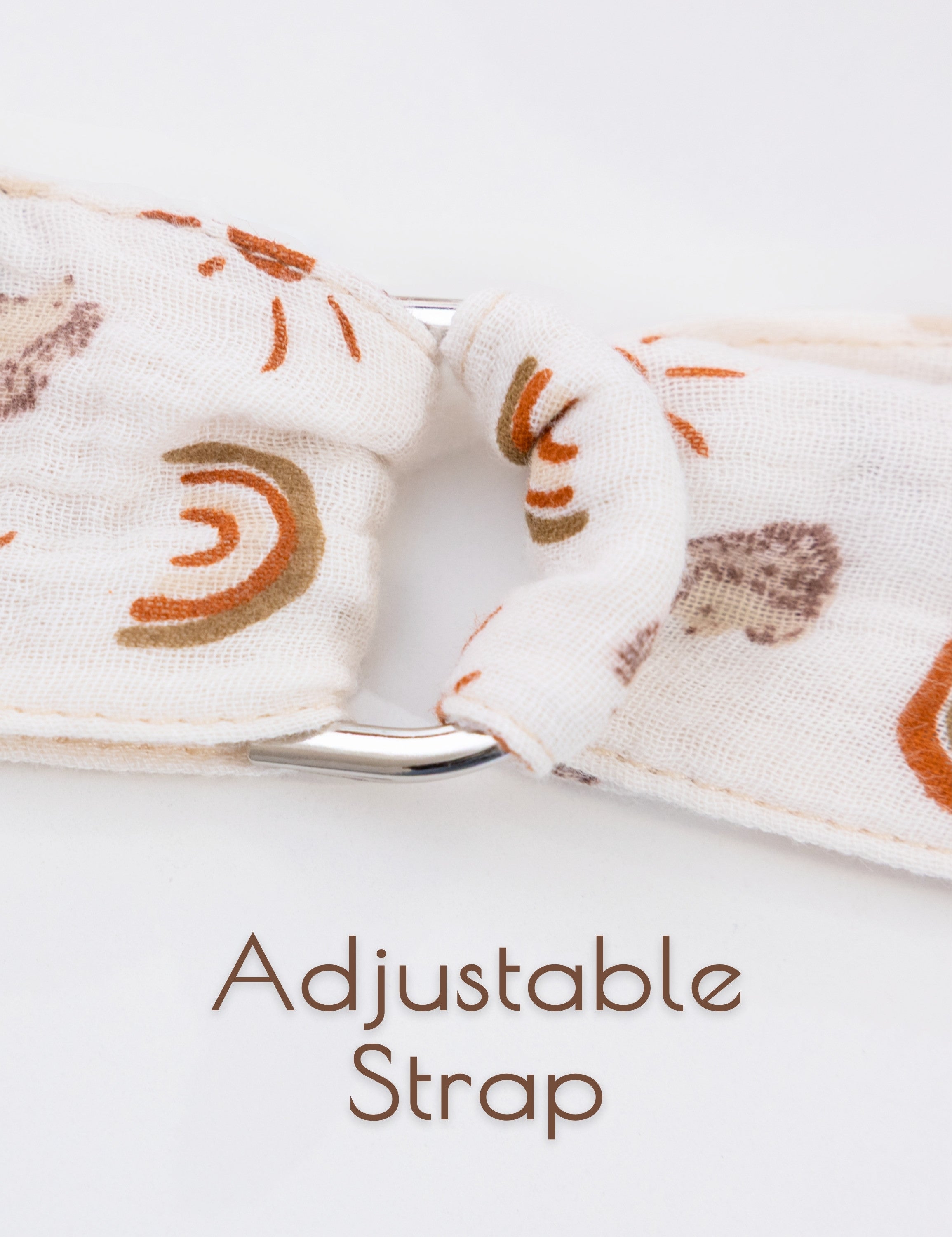 Rainbow patterned beige adjustable strap of a muslin nursing cover